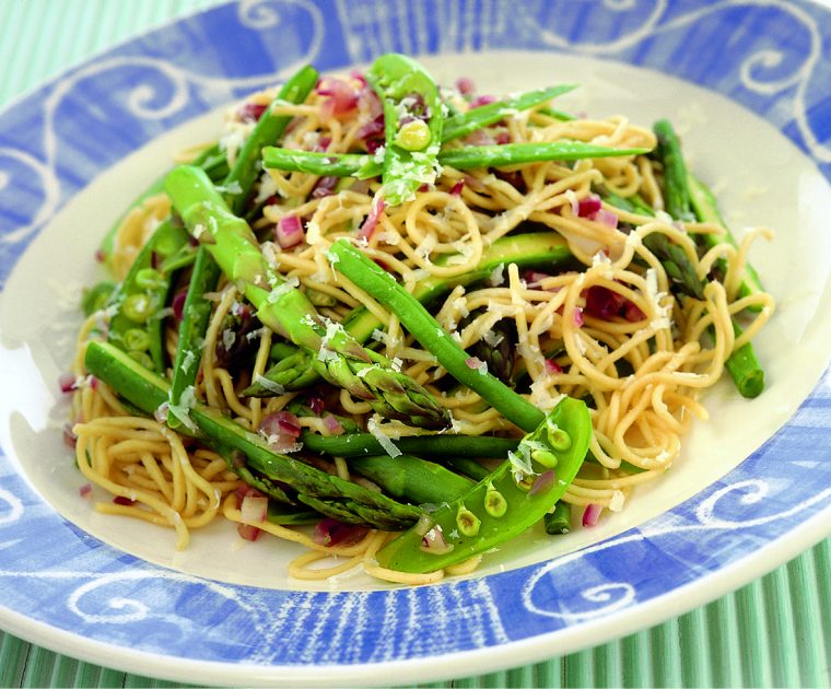 Plate of noodles mixed with green beans, asparagus and pea-pods