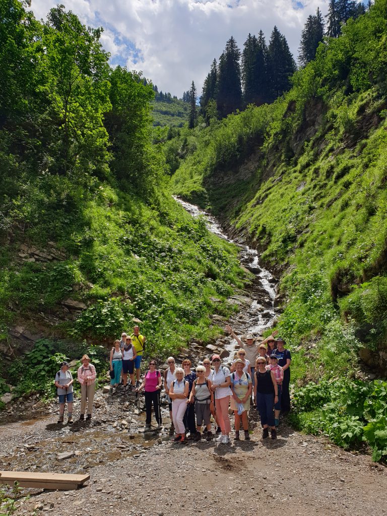 Austrian Activity Holiday group posed beside a stream running down the mountain