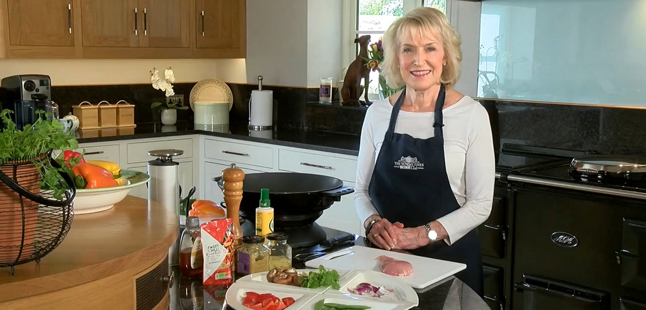 Rosemary Conley Recipes: Rosemary pictured wearing an apron standing at her kitchen worktop with a selection of ingredients in preparation for cooking a recipe.