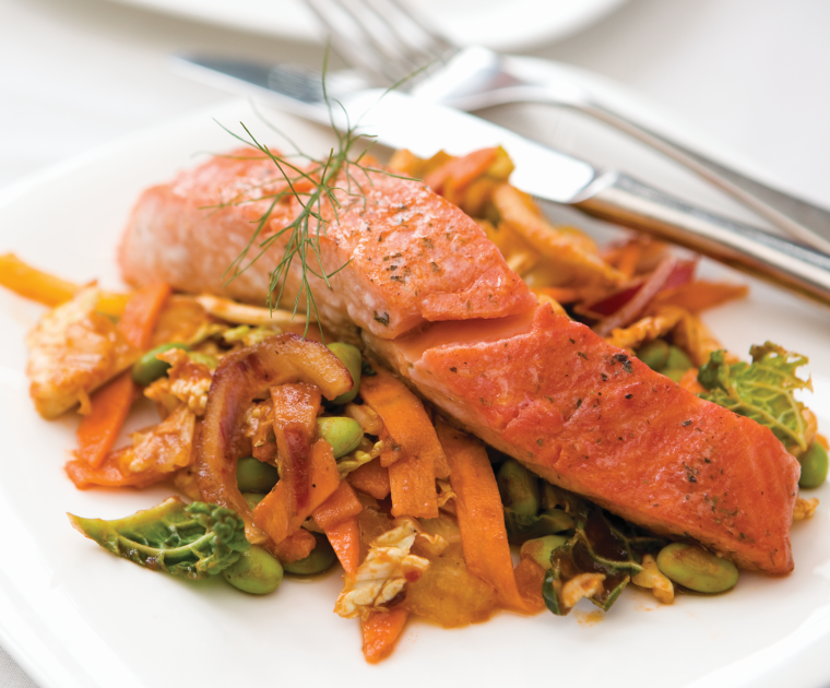 Tandoori Salmon with Spicy Noodles is a fillet of salmon dusted with curry powder and baked, resting on a bed of stir-fired noodle and vegetables