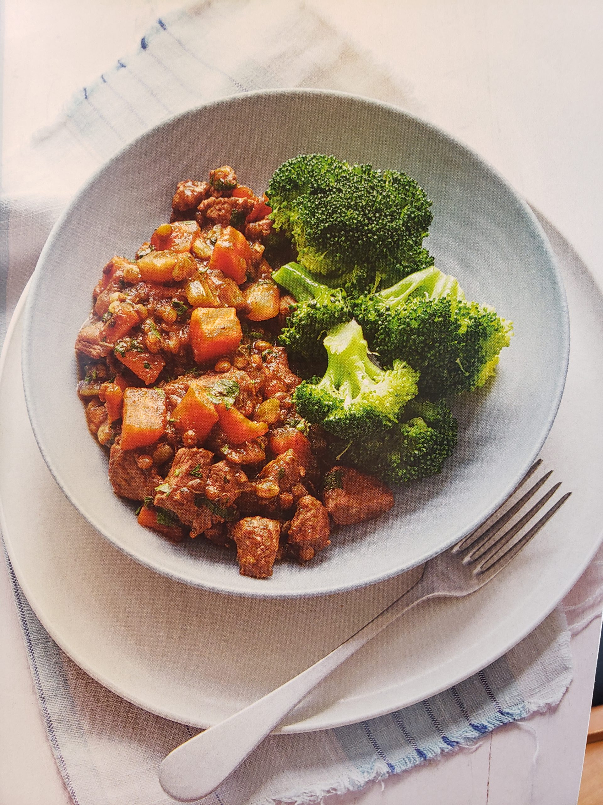 Lamb and Pearl Barley Casserole has pieces of tender lamb with diced carrots and turnip in a rich sauce served with fresh broccoli florets.