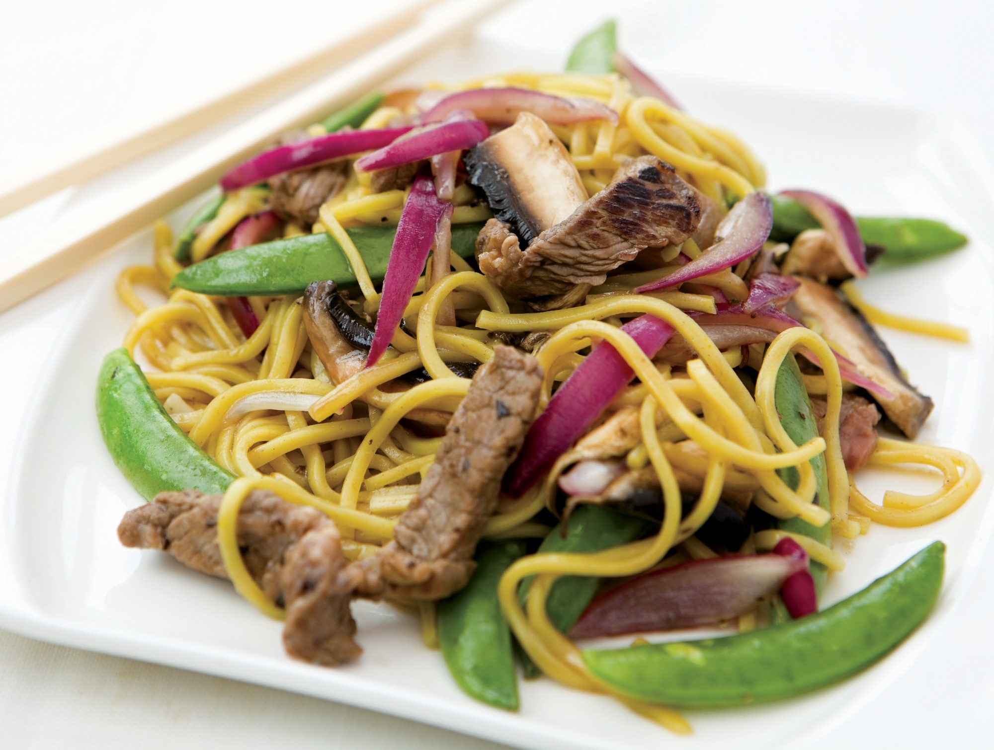 Sticky Beef and Mushroom Noodles is a stir-fry recipe with strips of rump steak, red onion, garlic, mushrooms and mangetout in a sticky plum sauce on a bed of noodles