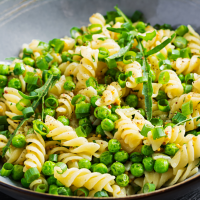 A bowl of Peas n Pasta with green peas and spring onion mixed with twists of pasta.