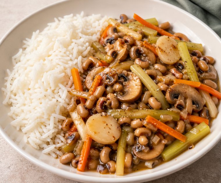 Blackeye Beans with Ginger and Soy is a vegan, plant based dish served with rice, made from blackeye beans, mushrooms, celery, carrots and water chestnuts all thinly sliced and cooked in a garlic, ginger and soy sauce.